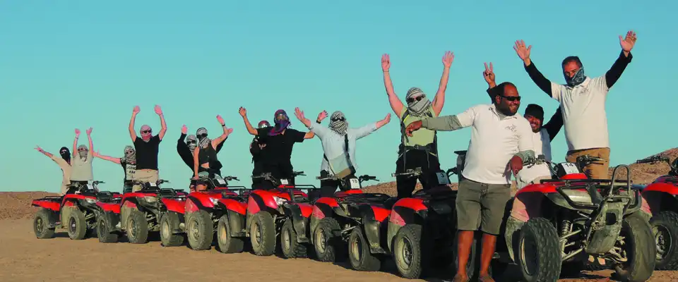 Quad group in the desert at sunset
